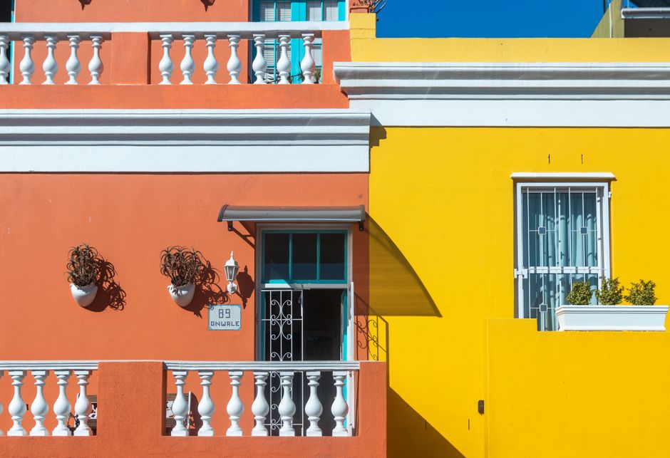 Painted house fronts in bright orange and yellow