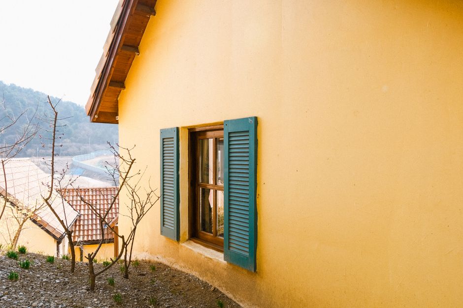 Yellow painted house with blue shutters